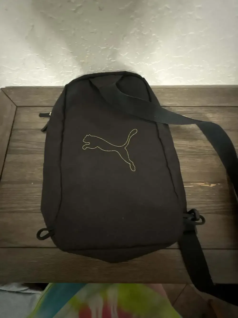 Puma Black Sling Backpack with Gold Logo